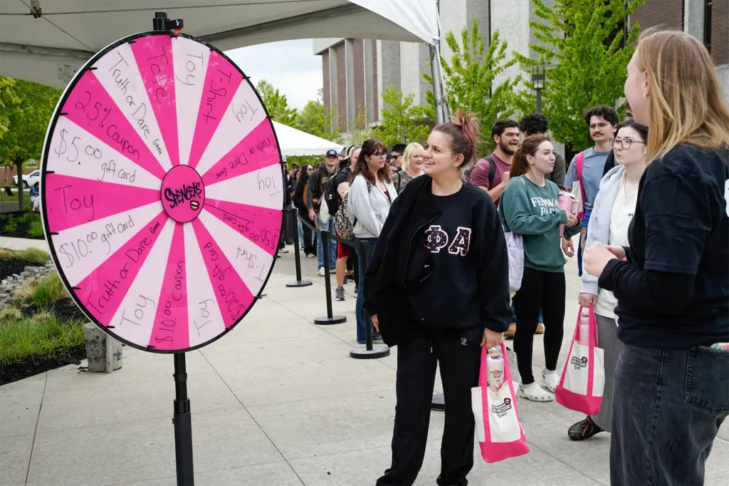 Students at Rowan University line up to spin a prize wheel at the "Sexology 101" event.