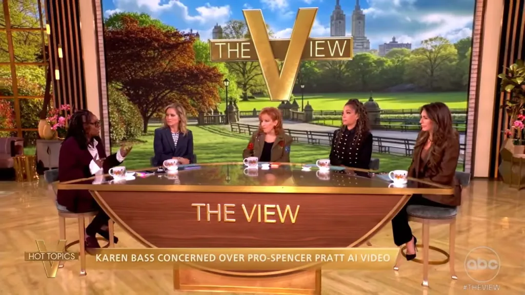 Five female panelists sit around a curved desk with "THE VIEW" emblazoned on the front.