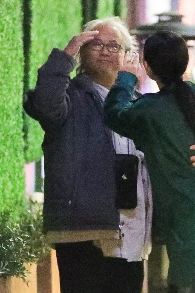 Kenneth Iwamasa waving goodbye to a friend.