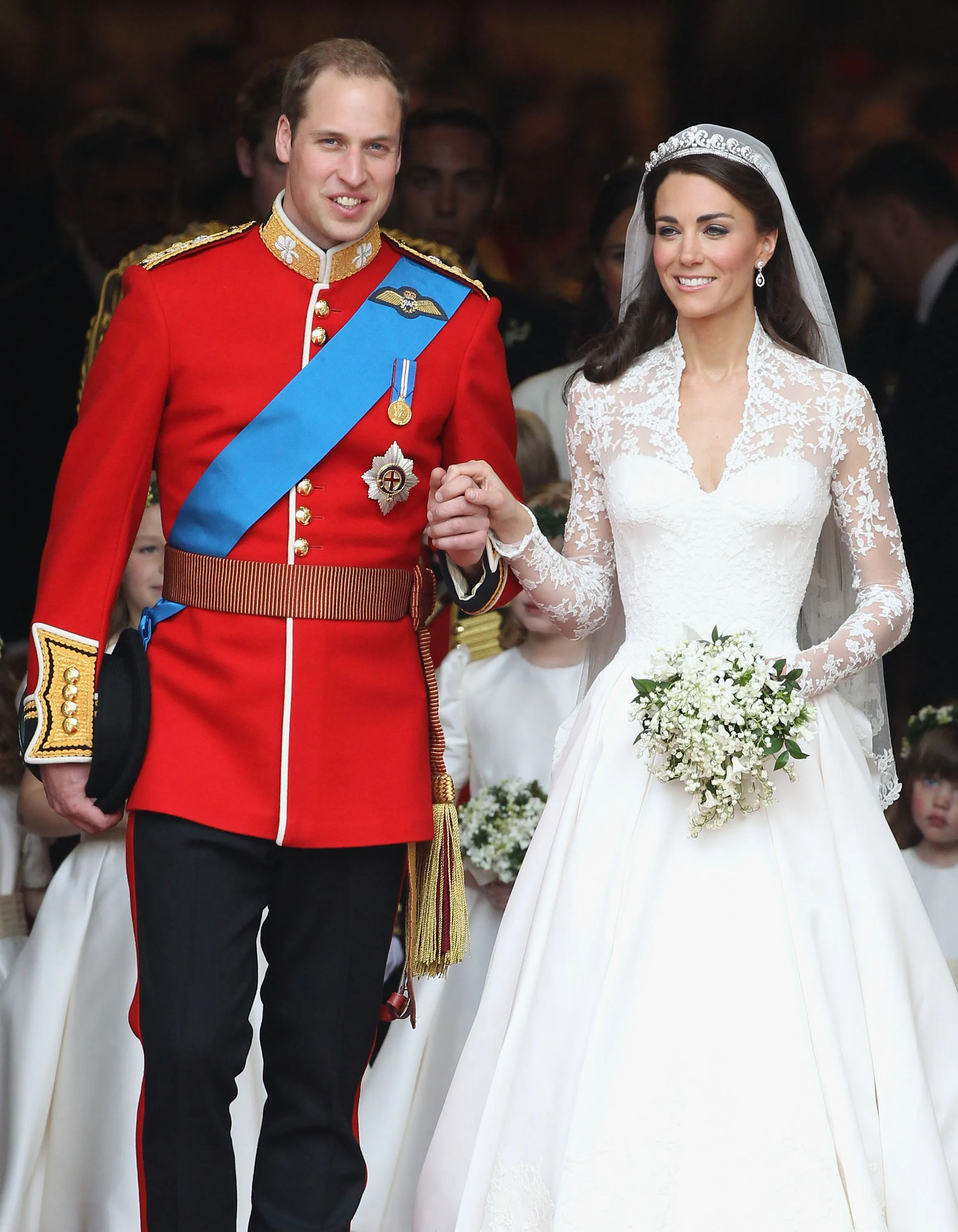Prince William and Kate Middleton holding hands after their wedding ceremony at Westminster Abbey.