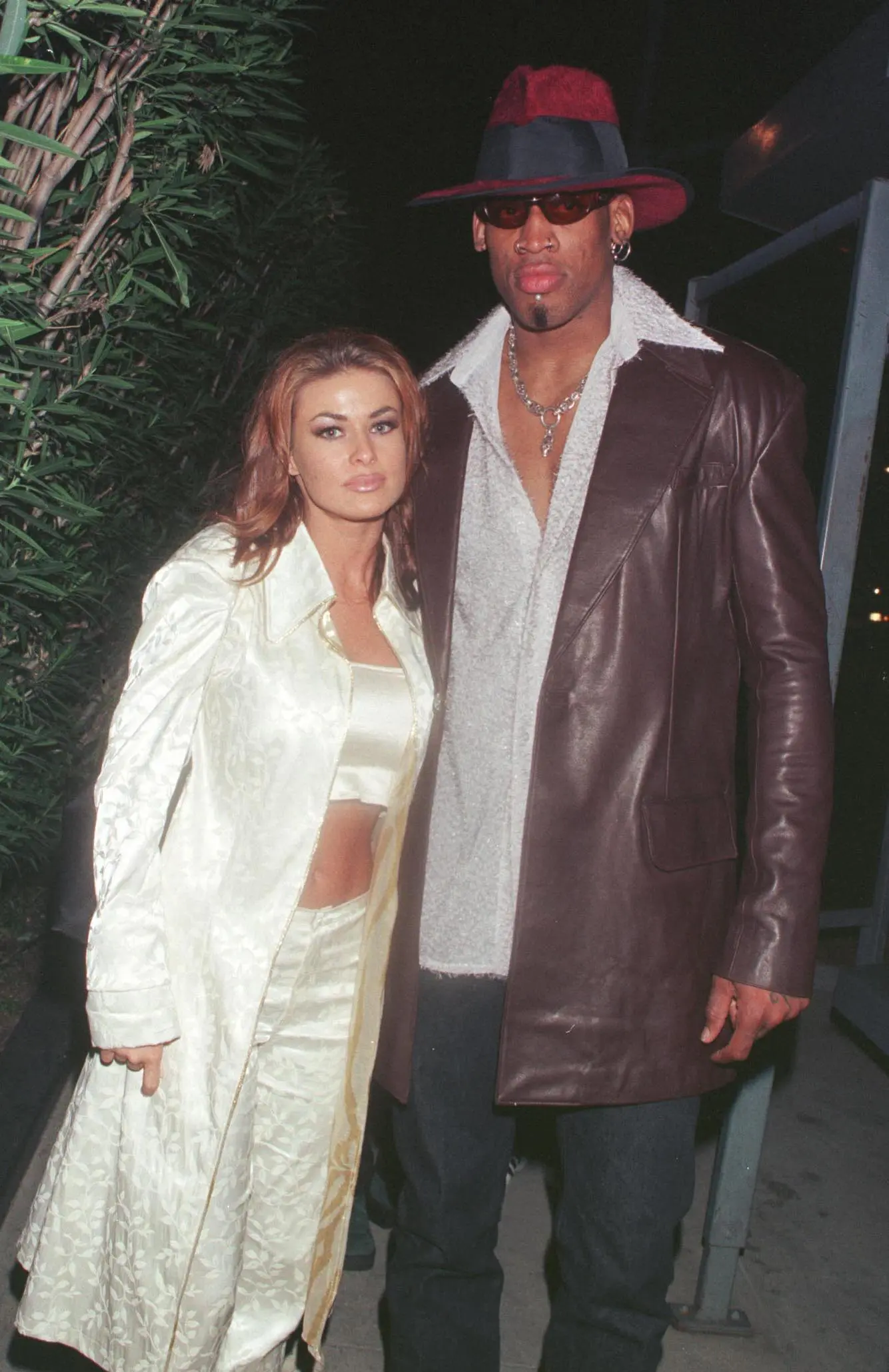 Carmen Electra and Dennis Rodman posing together at an event.