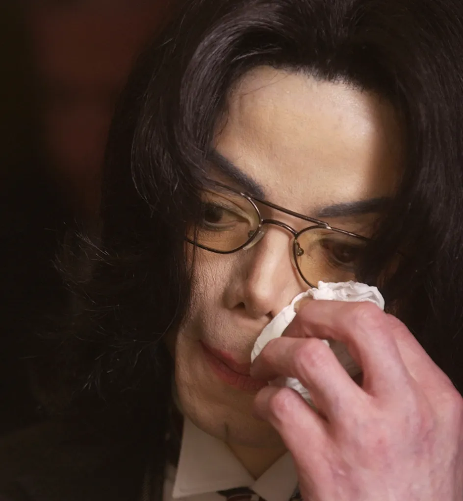 Michael Jackson wiping his nose with a tissue in court.