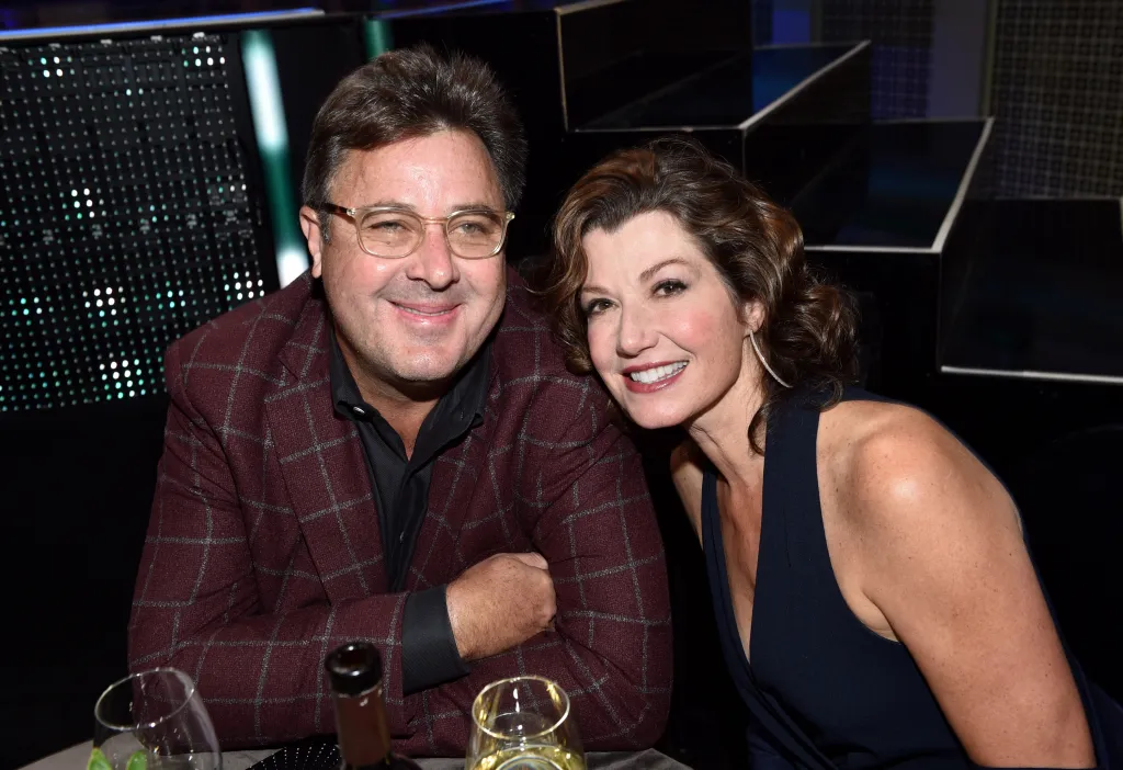 Singer-songwriters Vince Gill and Amy Grant smiling.
