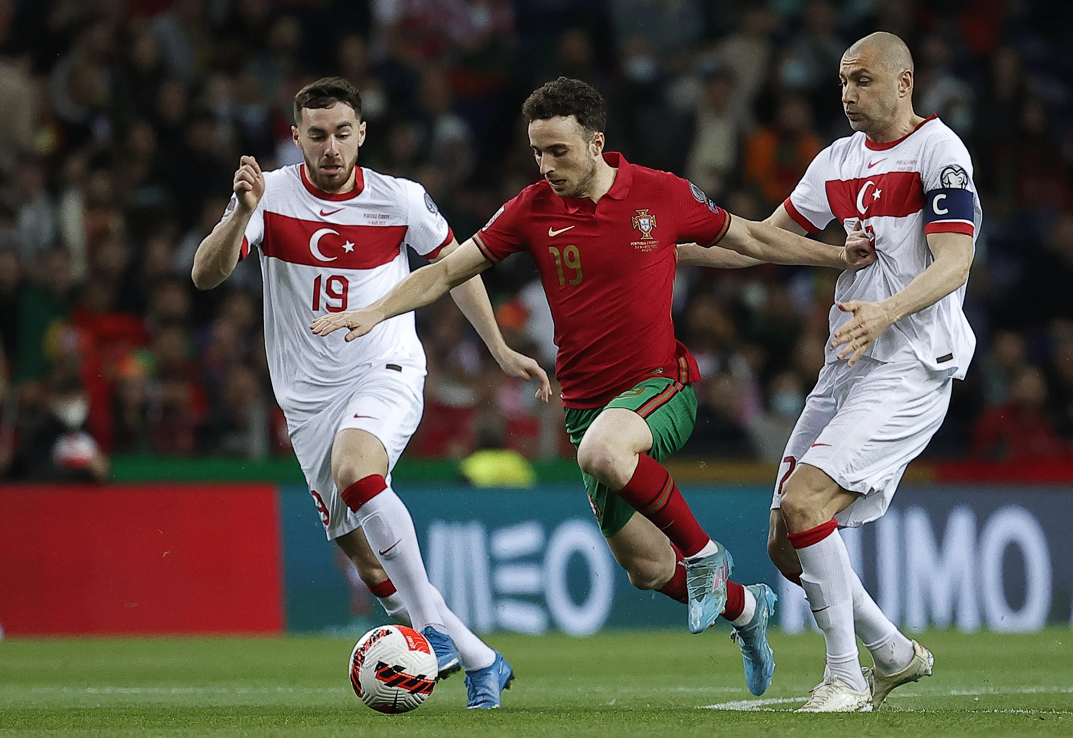 Diogo Jota of Portugal being in action against Burak Yilmaz and Orkun Kokcu of Turkiye during a football match.