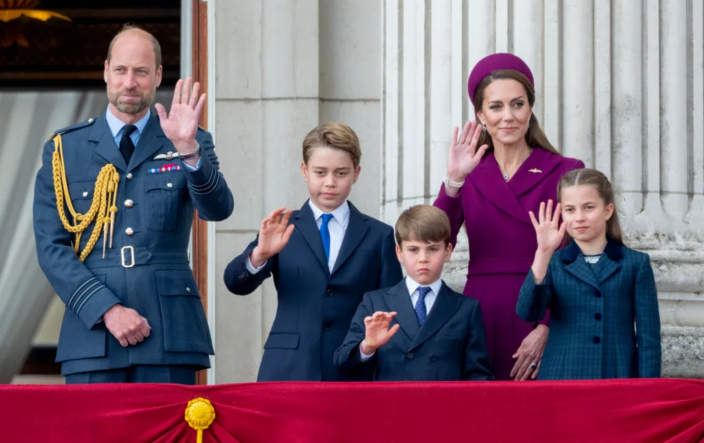 Prince William, Catherine, and their three children wave from the balcony of Buckingham Palace.