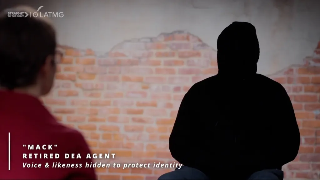 An interview with a silhouetted figure identified as "Mack," a retired DEA agent, with his voice and likeness hidden to protect his identity.