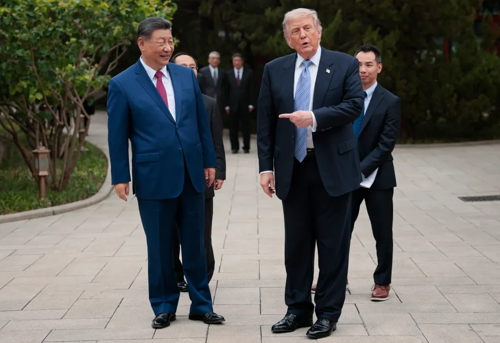 U.S. President Donald Trump gestures towards Chinese President Xi Jinping during a visit to Zhongnanhai Garden.