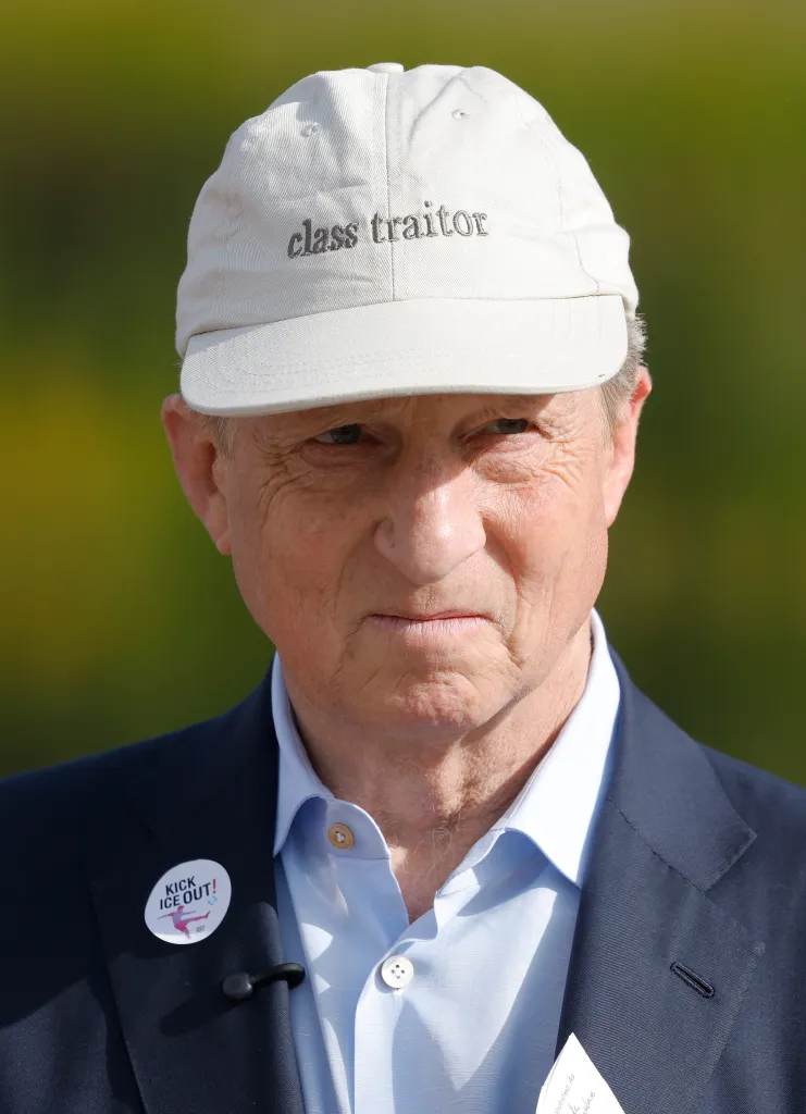 Tom Steyer wearing a "class traitor" cap and a "Kick ICE Out!" button at a union protest.