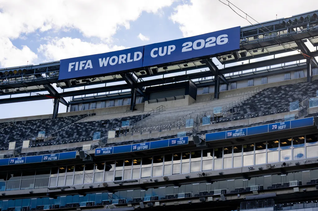 A blue sign with "FIFA World Cup 2026" written in white lettering hangs above MetLife Stadium.