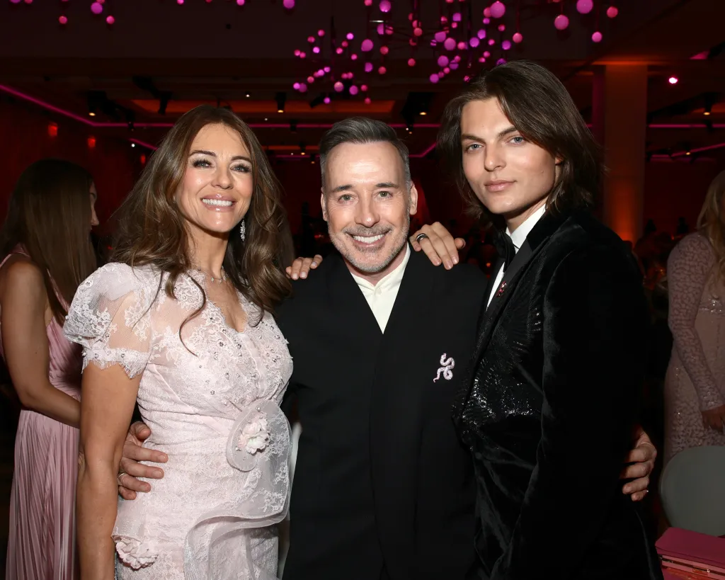 Elizabeth Hurley, David Furnish, and Damian Hurley pose together at the Breast Cancer Research Foundation Hot Pink Party 2026.