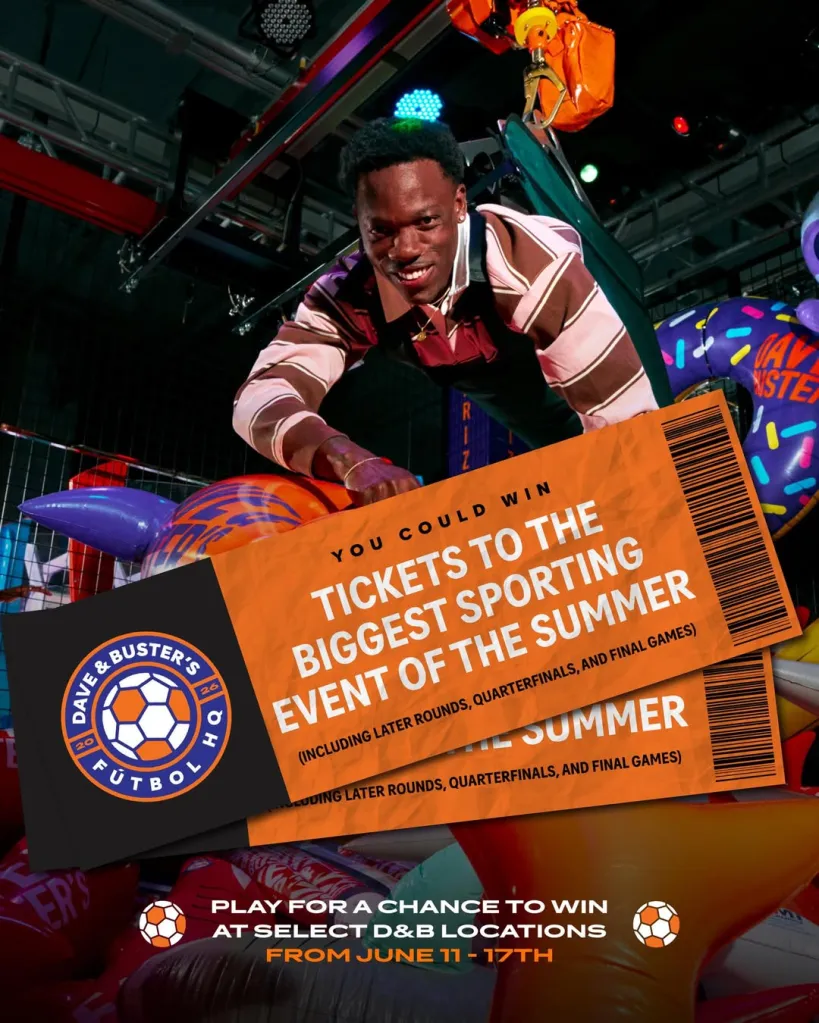 Man smiling while suspended above prize tickets for a sporting event, with a