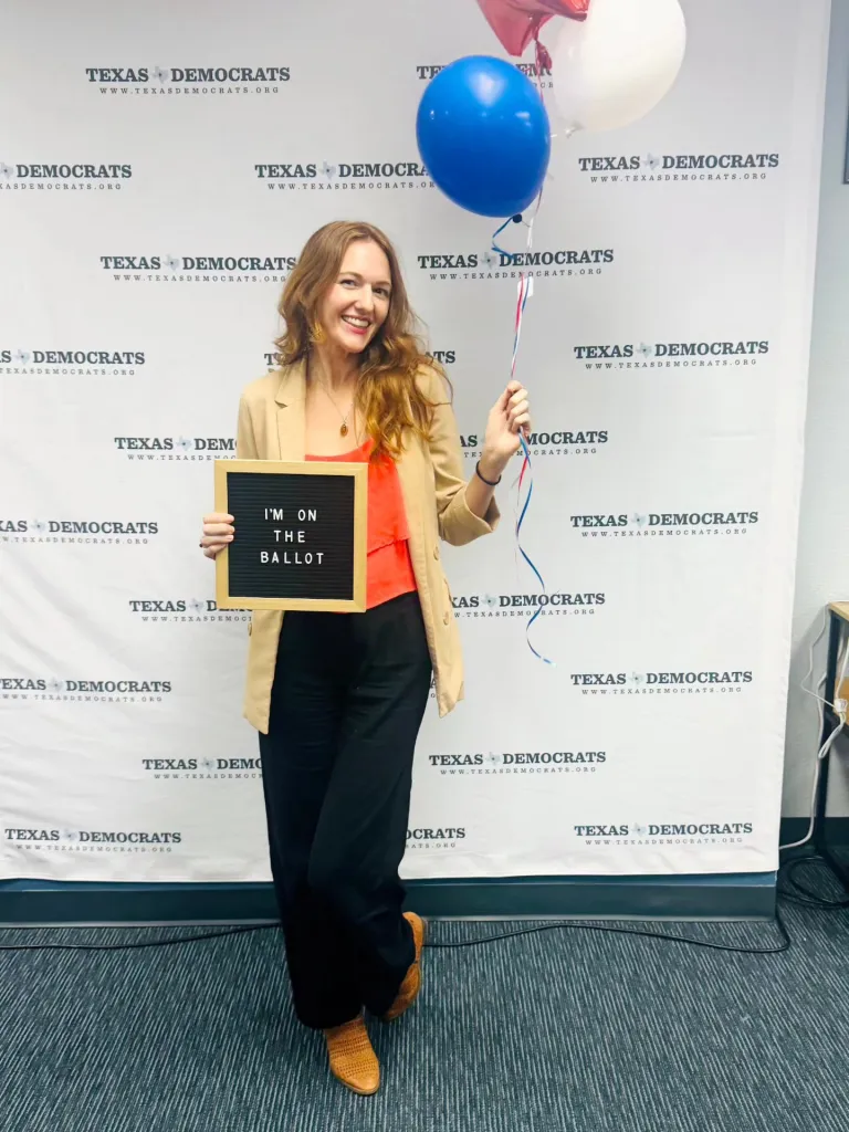 A woman holds a sign that reads