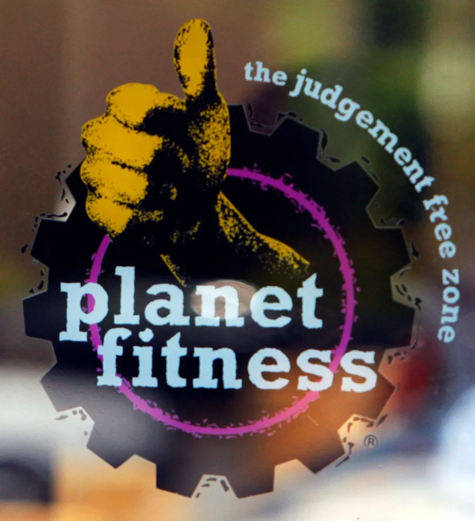 Planet Fitness logo with a yellow thumbs-up, black gear, and text "planet fitness" and "the judgement free zone".