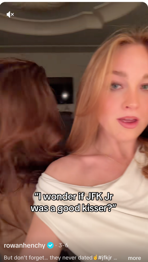 A woman with blonde hair and a white top is visible, with text overlay asking, "I wonder if JFK Jr was a good kisser?"