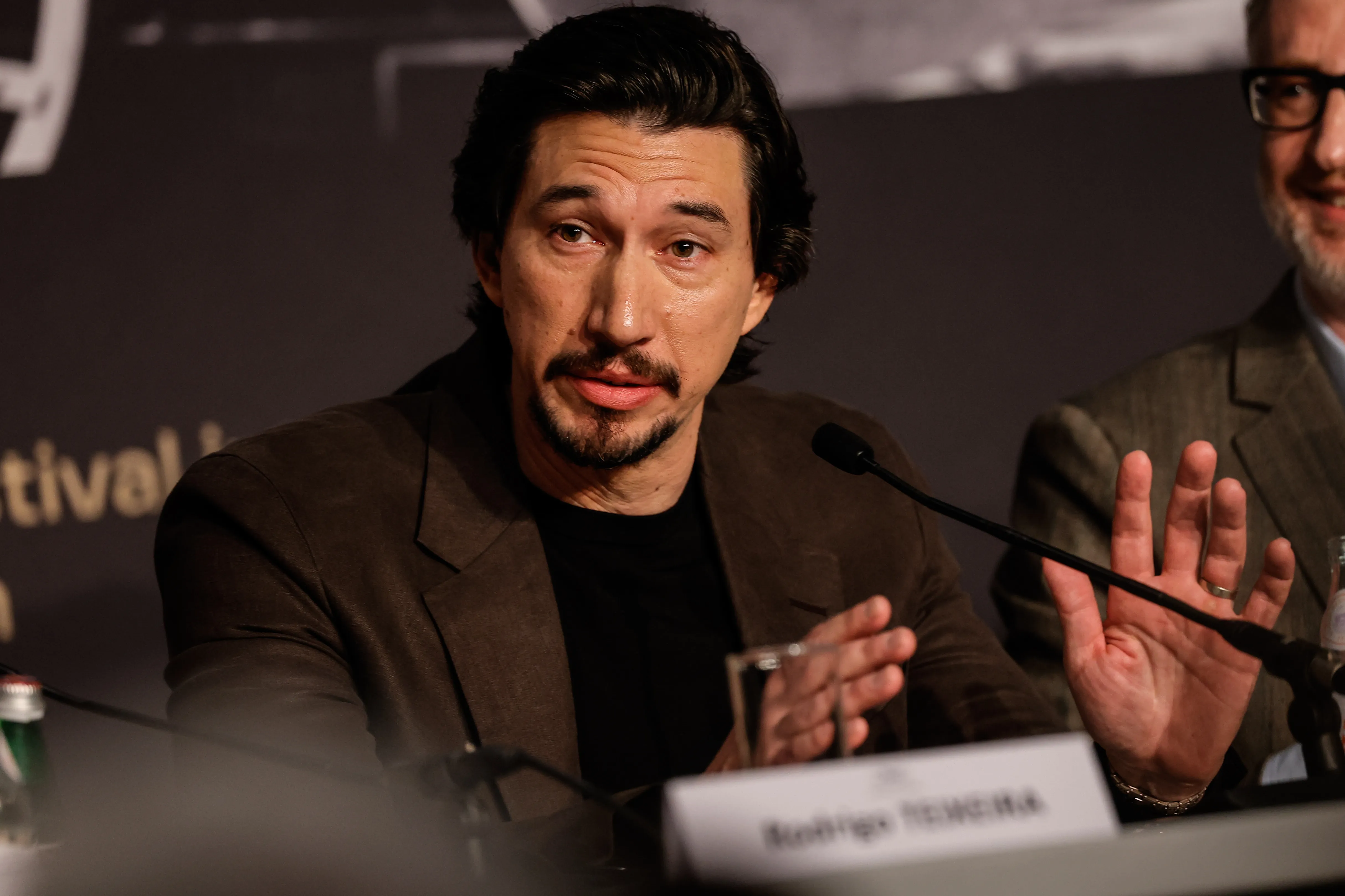 Adam Driver speaking at a press conference.