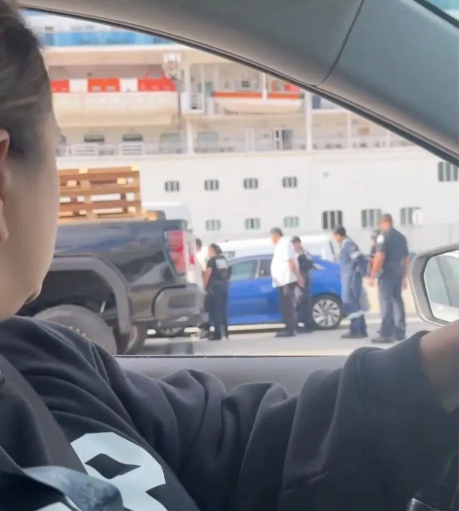 Passenger observing law enforcement agents arresting cruise ship crew members.