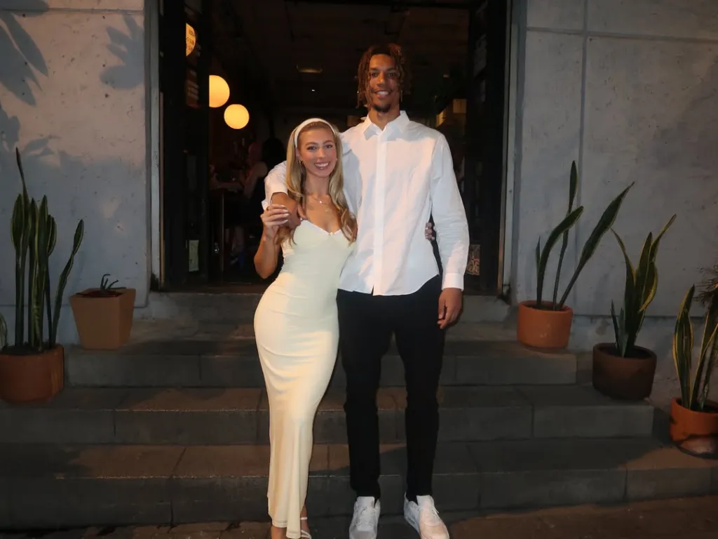 Amber Lorraine and Brandon Clarke posing for a photo outdoors.
