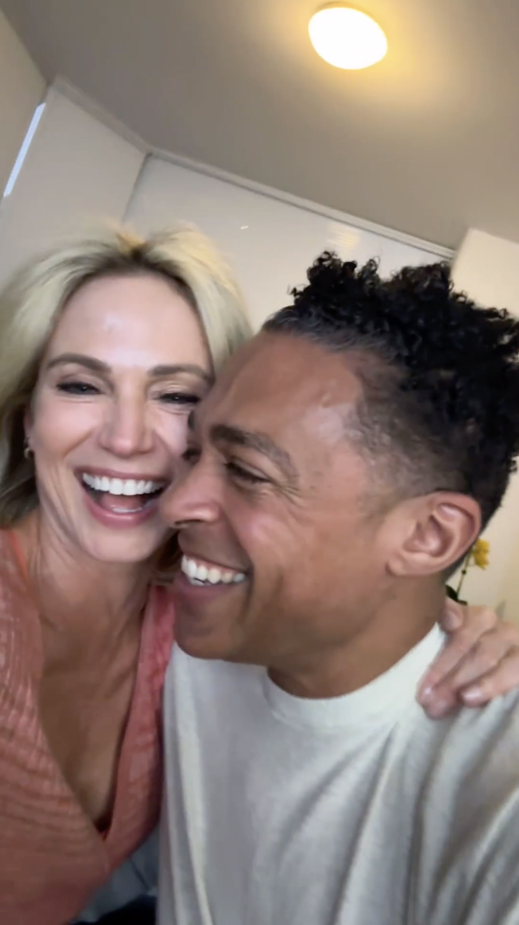 Amy Robach and T.J. Holmes smiling and laughing.