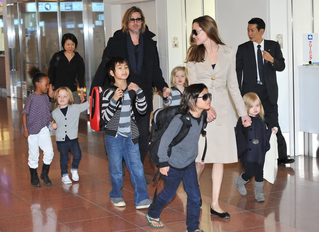 Brad Pitt,. in a black coat and black top, and Angelina Jolie, in a camel colored coat, with their children. From left, Zahara Jolie, in a print top and white jeans, Knox Jolie-Pitt in a grey cardigan, black T-shirt and blue jeans, Maddox Jolie, in a grey striped T-shirt and black and grey striped cardigan and blue jeans, Pax Jolie-Pitt in a grey sweater and blue jeans, Shiloh Jolie, in a grey striped cardigan and Vivienne Jolie in a black cardigan, black leggings and grey boots.