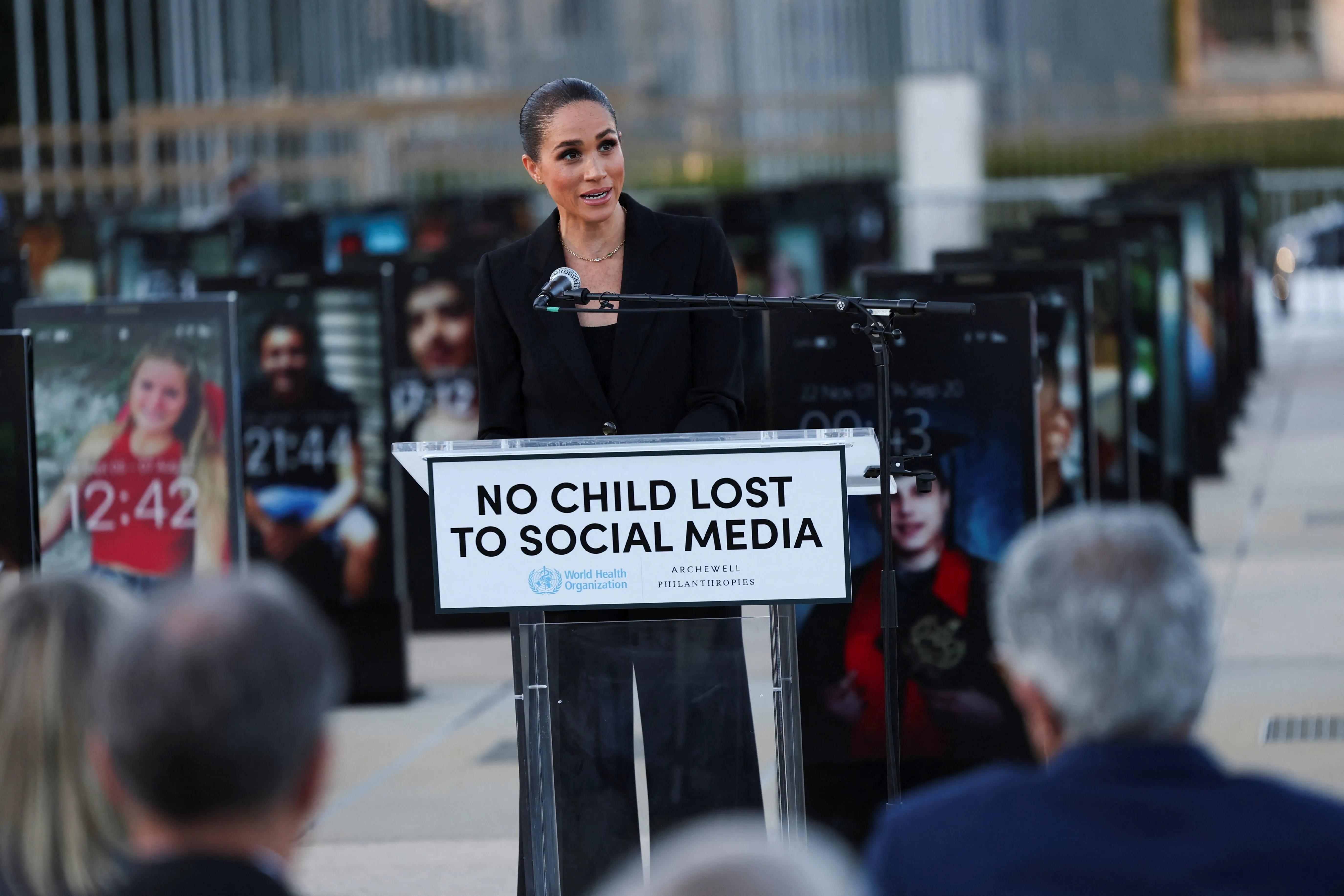 Meghan, Duchess of Sussex, speaks at a podium with a sign that reads "NO CHILD LOST TO SOCIAL MEDIA."