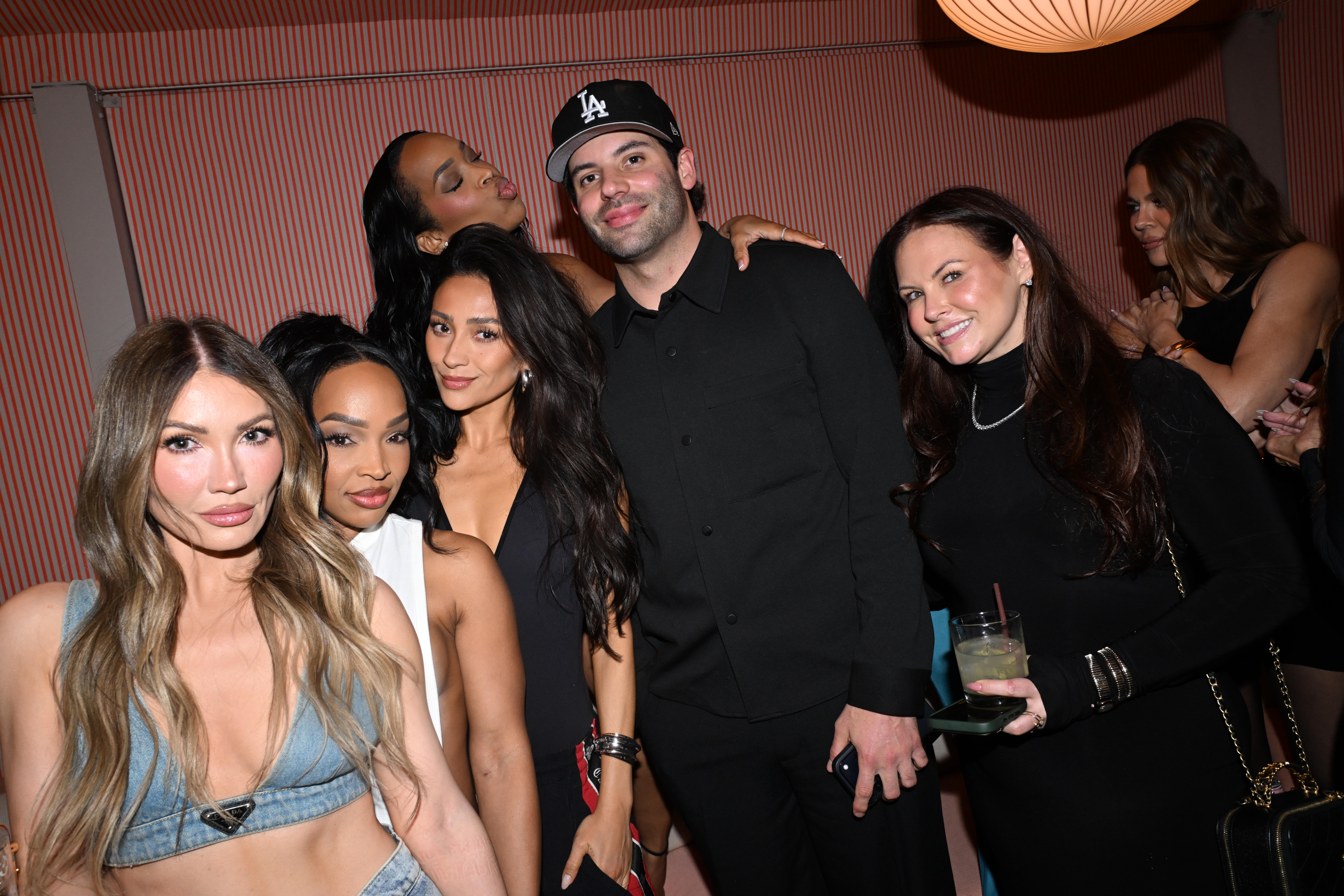 Cam Fordham in a black shirt and LA Dodgers cap, with Khloe Kardashian and other guests at Fordham's 35th birthday party.