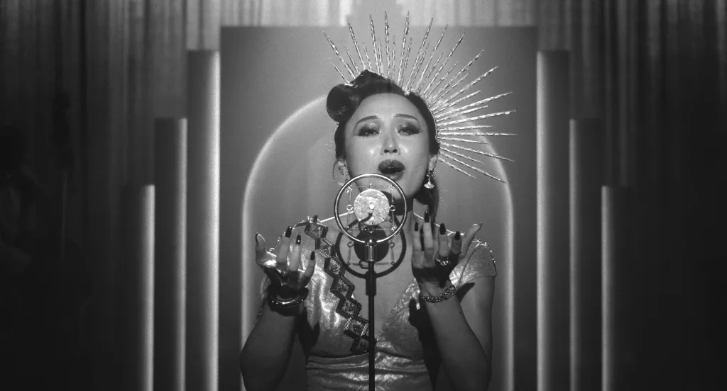 Li Jun Li as Cat singing into a microphone in a scene from Prime Video's Spider-Noir.