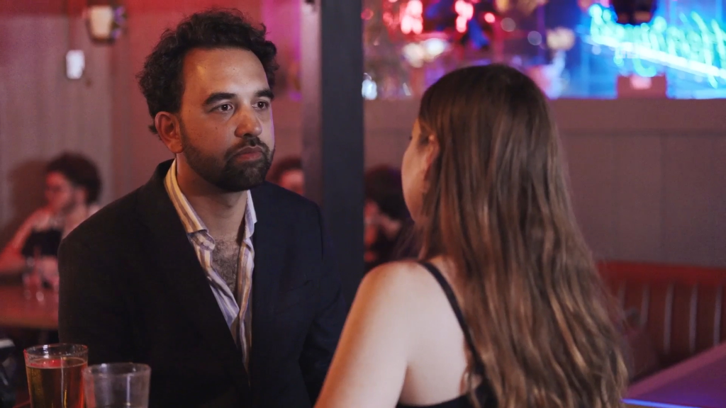 Josh looks at Catie in a bar.