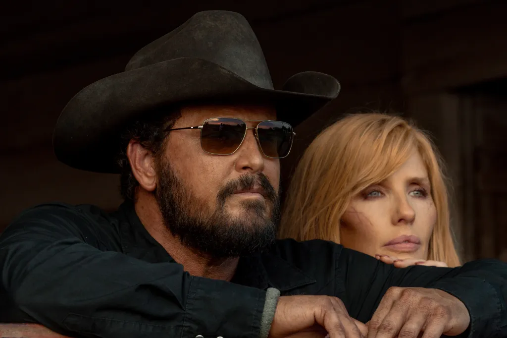 Cole Hauser as Rip Wheeler wearing a cowboy hat and sunglasses, and Kelly Reilly as Beth Dutton in Dutton Ranch.
