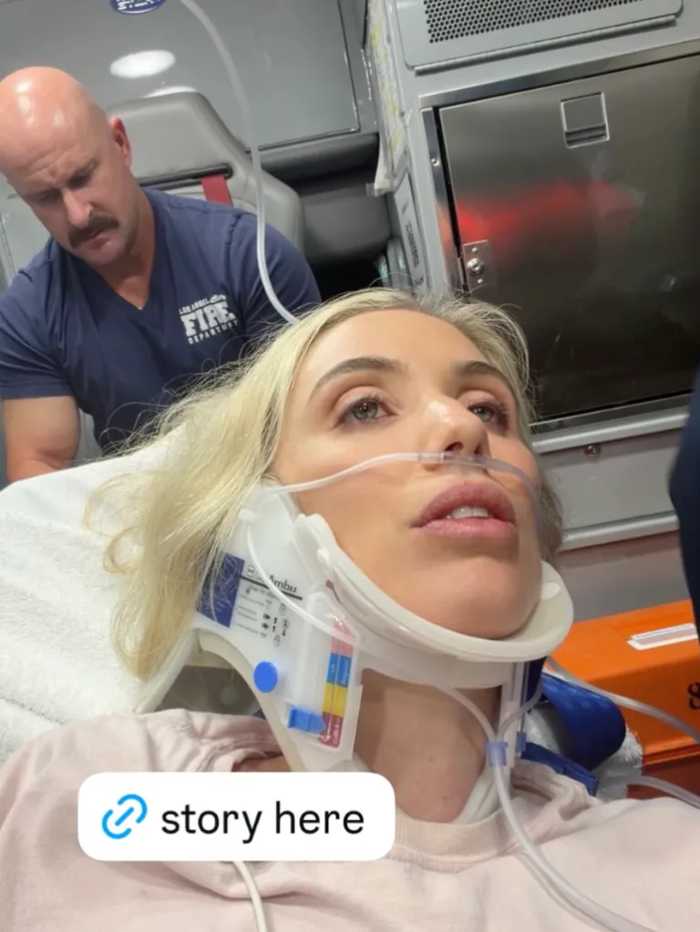 Laura Clery in a neck brace in an ambulance, with a paramedic in the background.