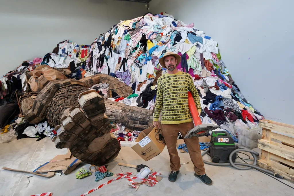 Thomas Dambo poses with his garbage art exhibition, "The Garbage Man," at Arken Museum of Contemporary Art.