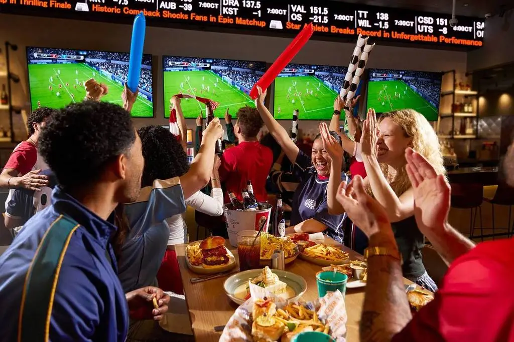 People cheering at Dave & Buster's while watching the World Cup.