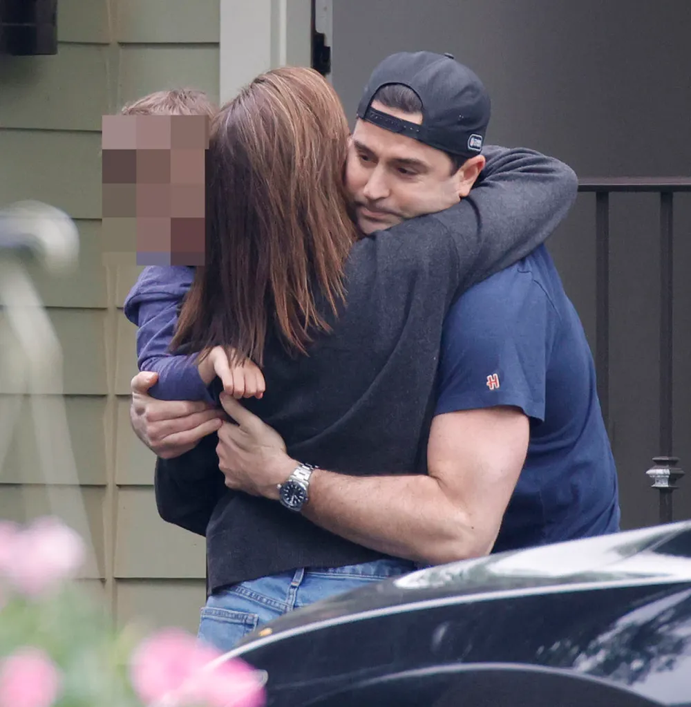Dianna Russini greeting her husband Kevin Goldschmidt and one of her children.
