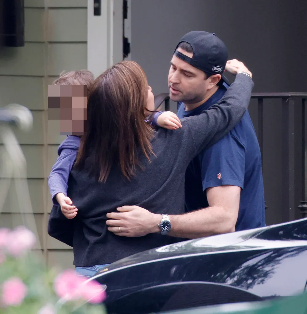 Dianna Russini greeting her husband Kevin Goldschmidt and her child.