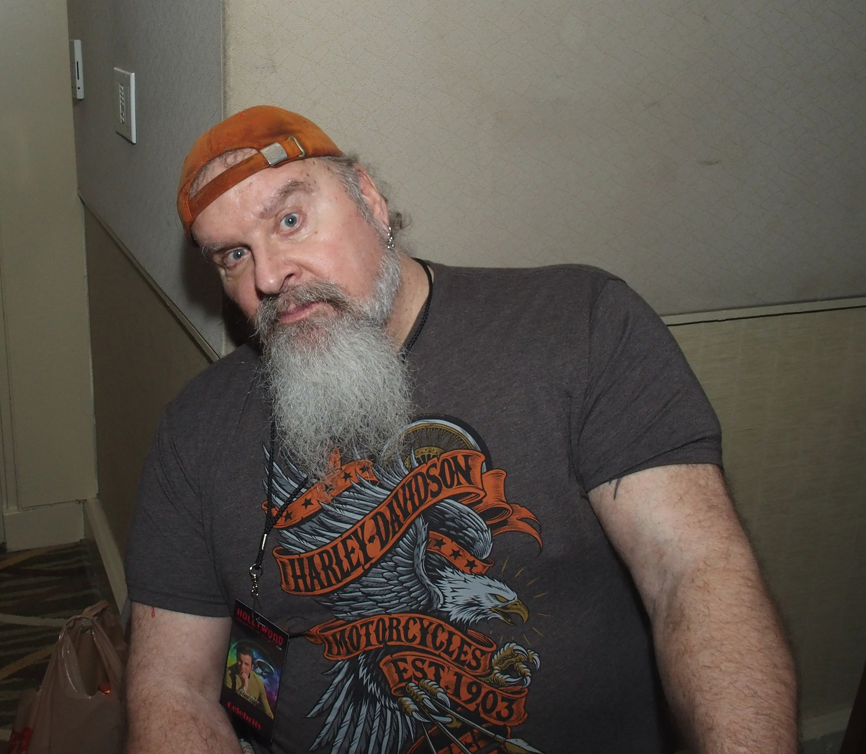 Donald Gibb in a grey Harley Davidson t-shirt and orange cap.