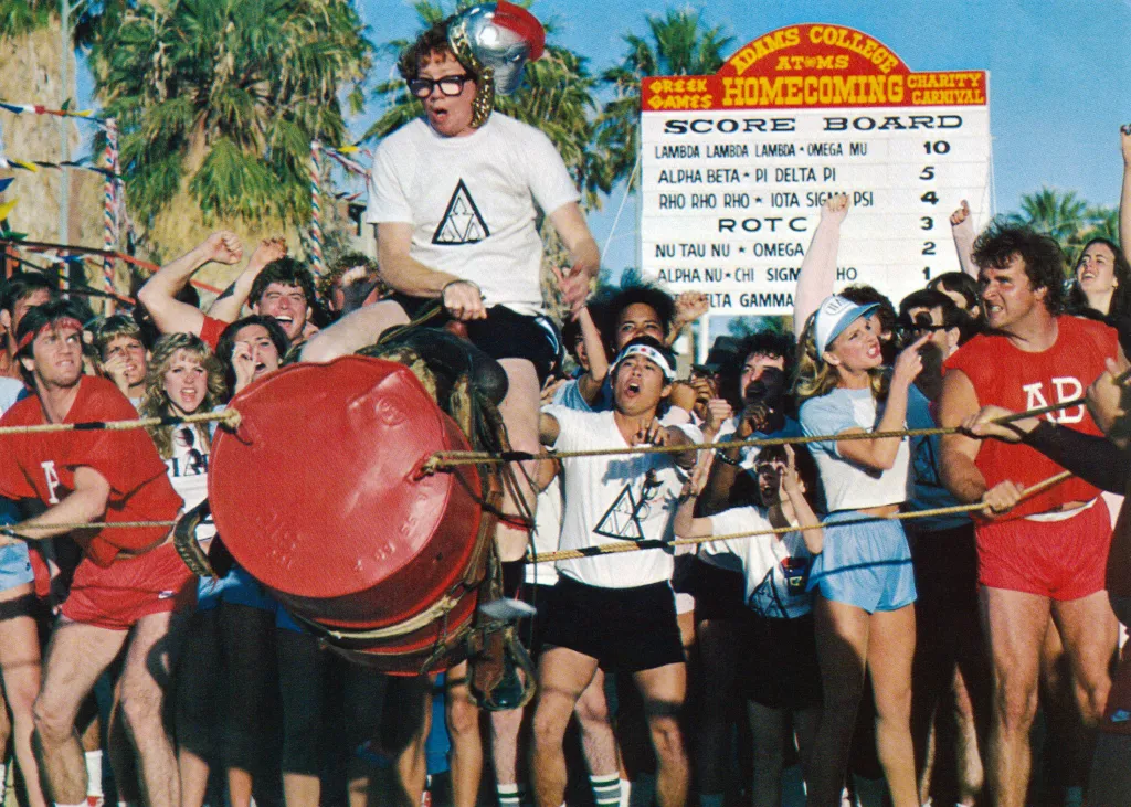 Timothy Busfield on top of Donald Gibb's shoulders, celebrating victory in