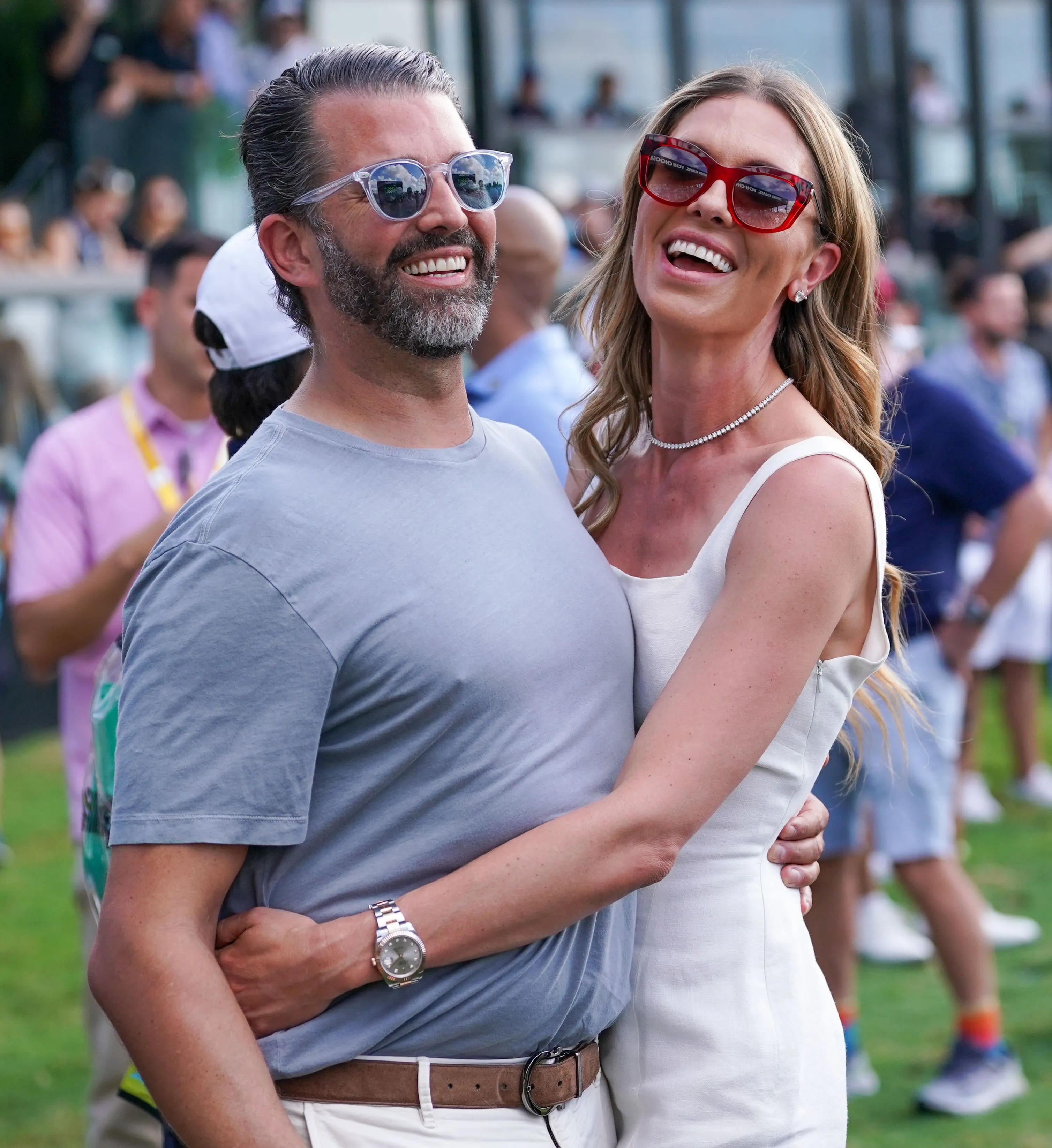 Donald Trump Jr. and Bettina Anderson embracing and smiling at the LIV Golf Miami event.