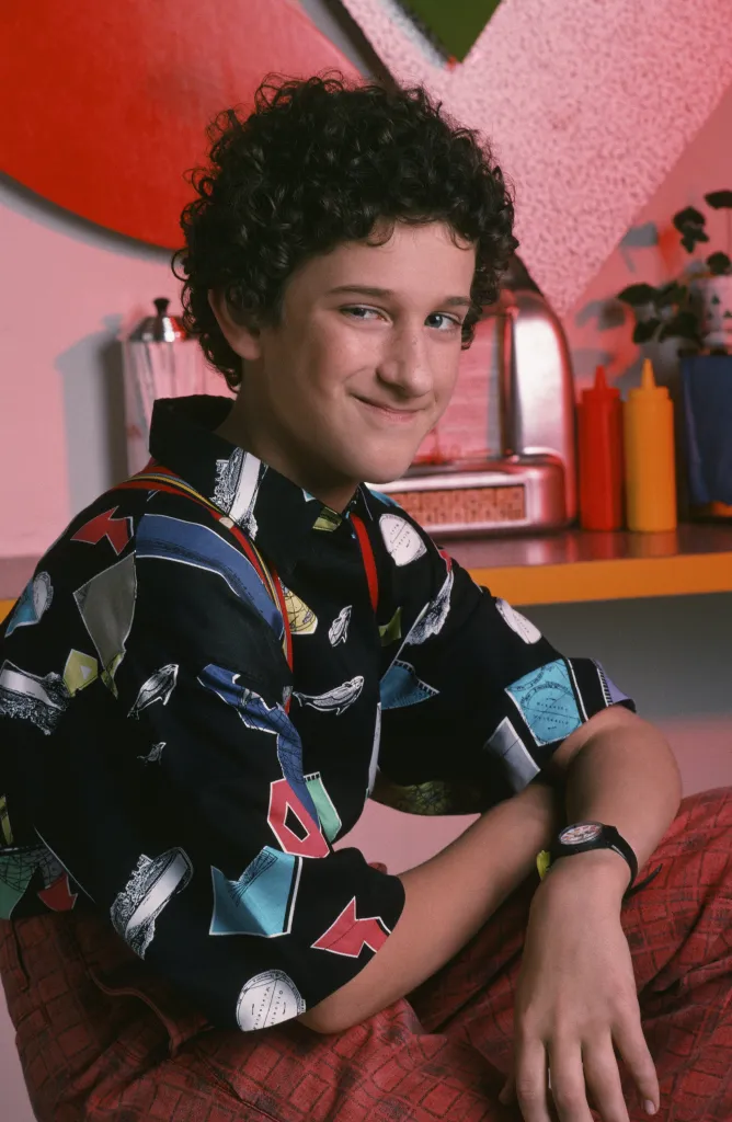 Dustin Diamond as Screech Powers smiling at the camera.