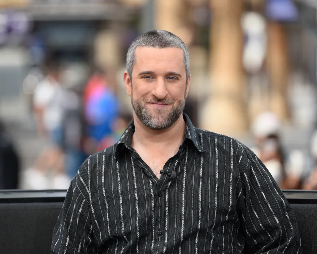 Dustin Diamond smiling while wearing a striped shirt.