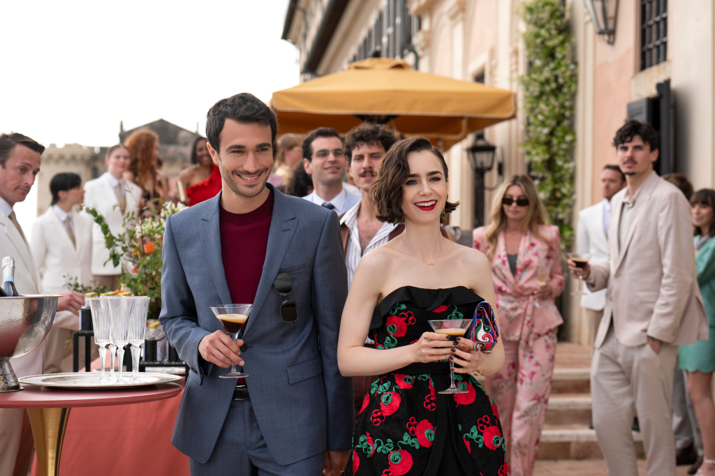 Eugenio Franceschini as Marcello and Lily Collins as Emily at a party in "Emily in Paris."