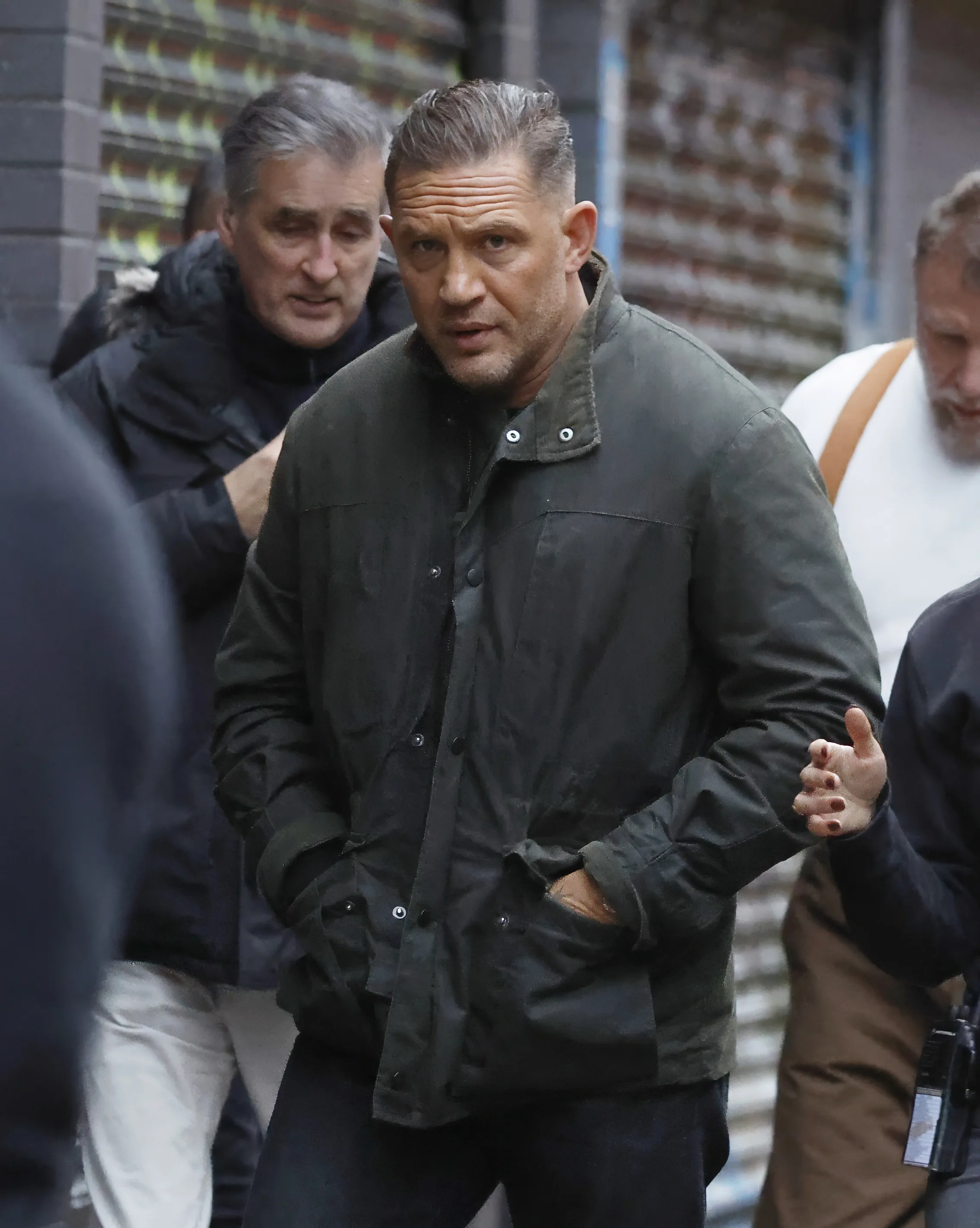 Tom Hardy in a dark green jacket on the set of MobLand.