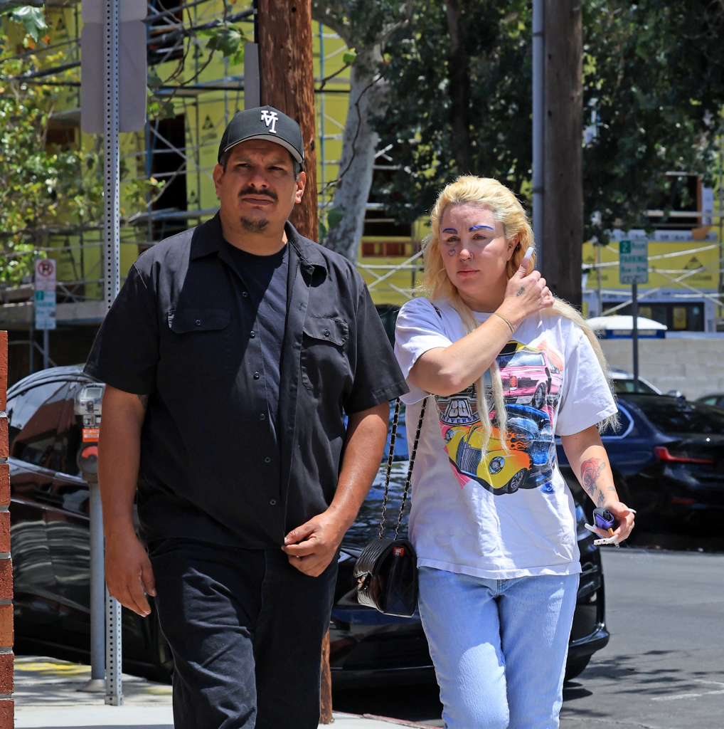 Amanda Bynes and Zachary Khan holding hands while walking outside in Los Angeles.