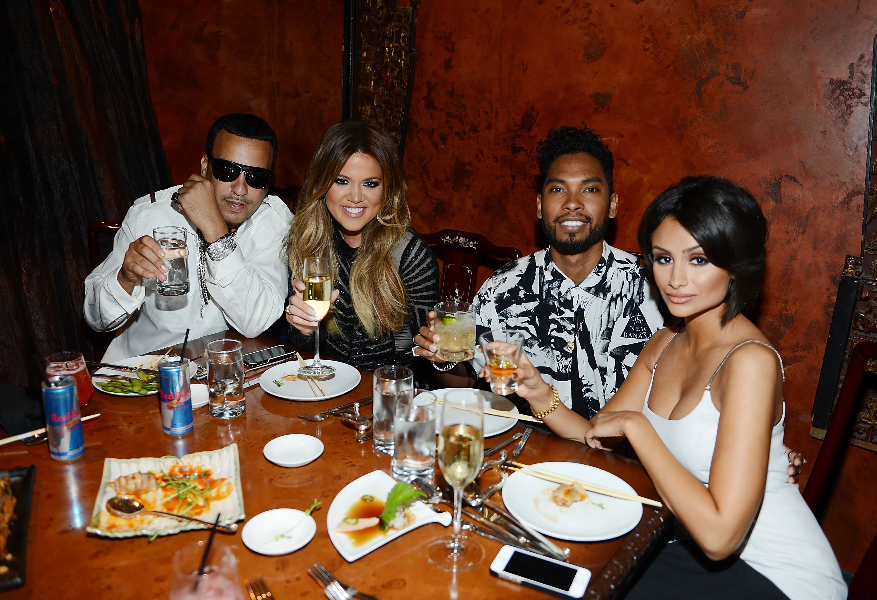French Montana, Khloé Kardashian, Miguel, and Nazanin Mandi posing with drinks at Khloé Kardashian's 30th birthday celebration.