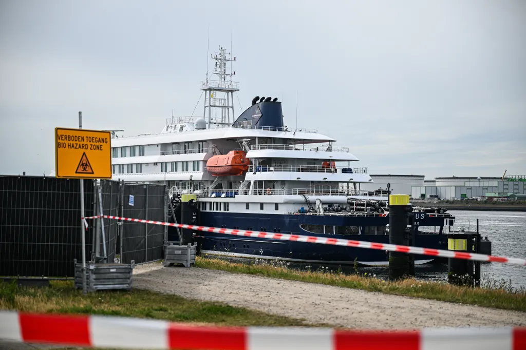 MV Hondius docked at the Port of Rotterdam with a "Bio Hazard Zone" sign and red and white caution tape in the foreground.