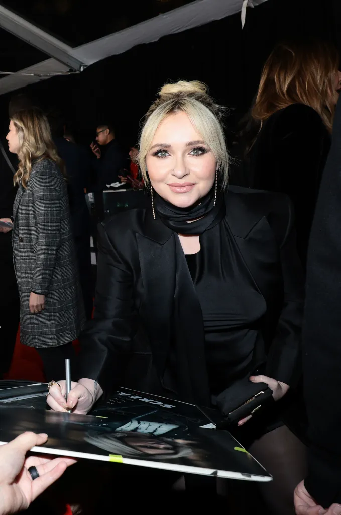 Hayden Panettiere signing an autograph.