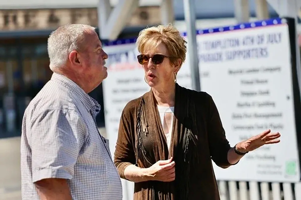 Stacy A. Korsgaden, a California insurance commissioner candidate, speaking to a man.