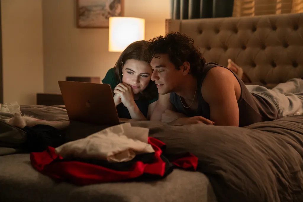 Ella Bright and Belmont Cameli looking at a laptop in "Off-Campus."
