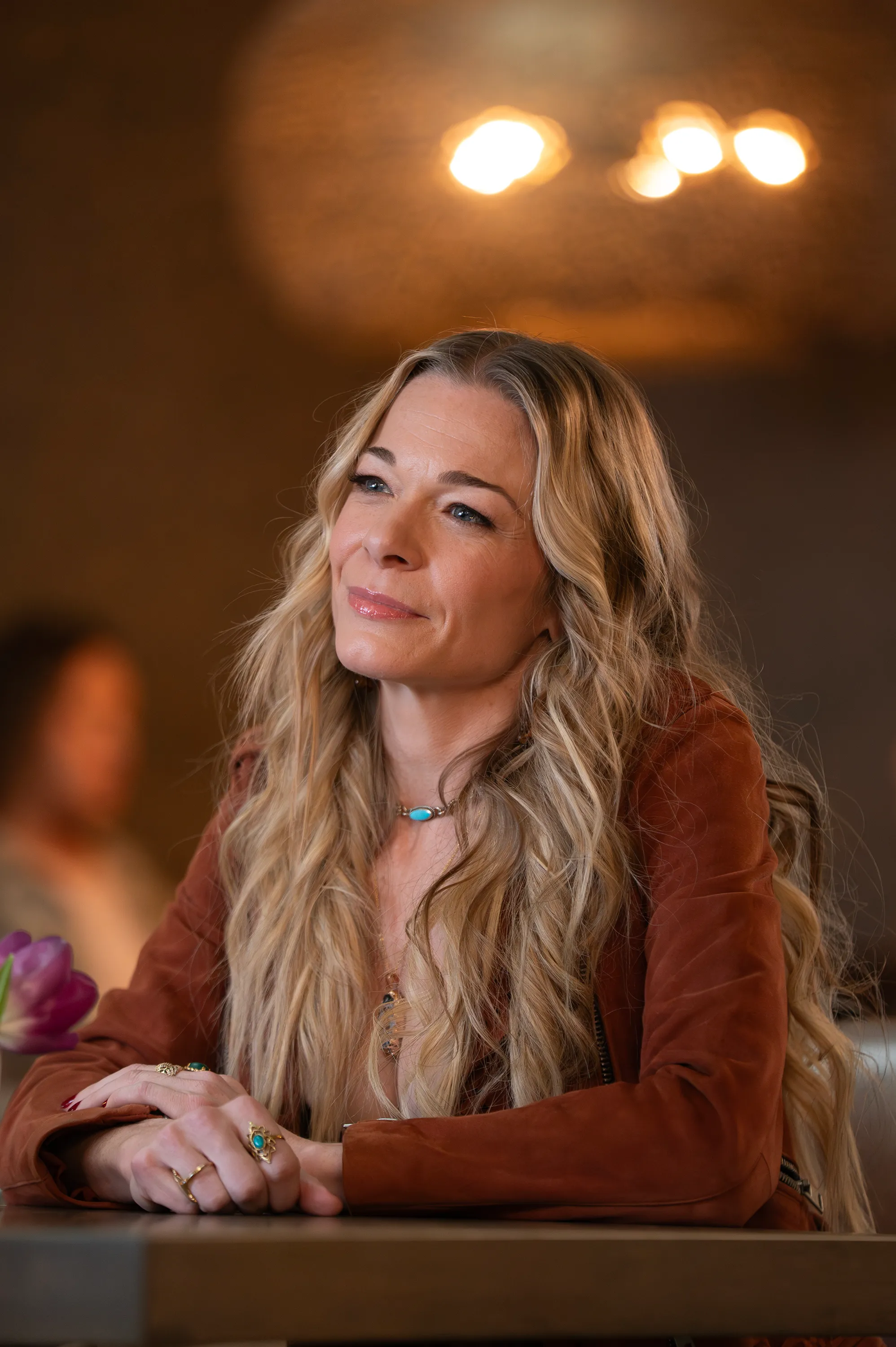 LeAnn Rimes looking upwards and smiling slightly.