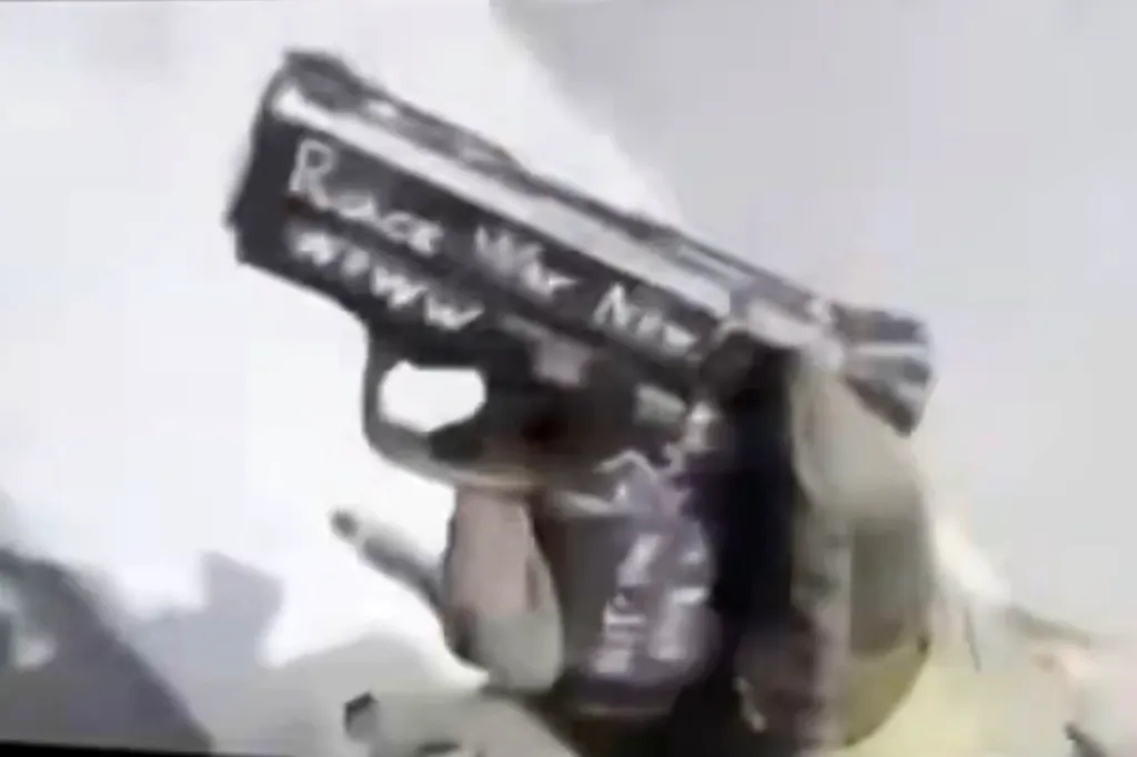 A gun with "Race War Now" written on it.