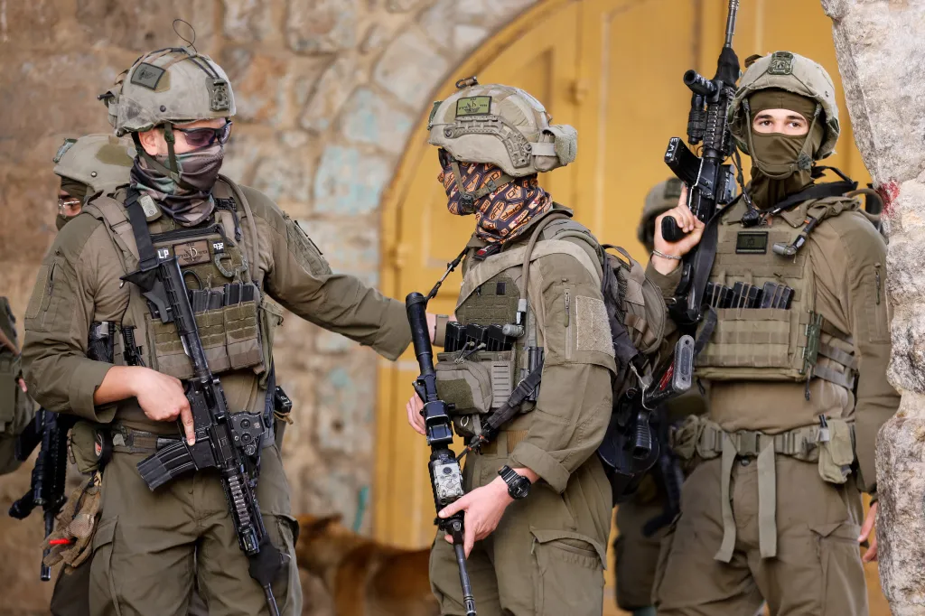 Israeli soldiers stand guard during a weekly settlers' tour in Hebron.
