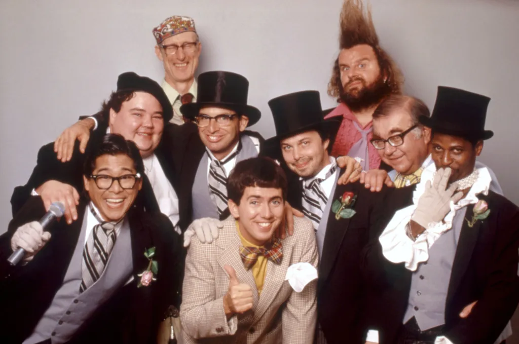 Cast photo for the movie "Revenge of the Nerds IV: Nerds in Love" featuring James Cromwell, Donald Gibb, John Pinette, Robert Carradine, Curtis Armstrong, Marvin Kaplan, Larry B. Scott, Brian Tochi, and Gregg Binkley.